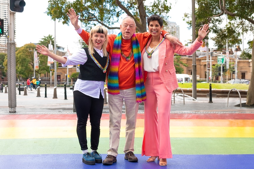Rudy Jean Rigg, Peter de Waal and Narelda Jacobs pose on a rainbow crossing in Sydney.