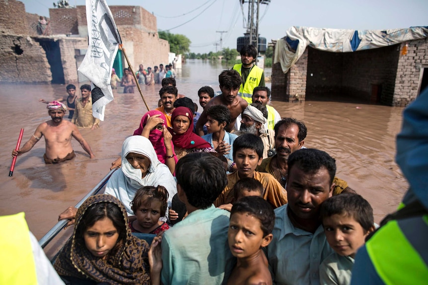 Survivors are evacuated by boat after devastating floods across India and Pakistan