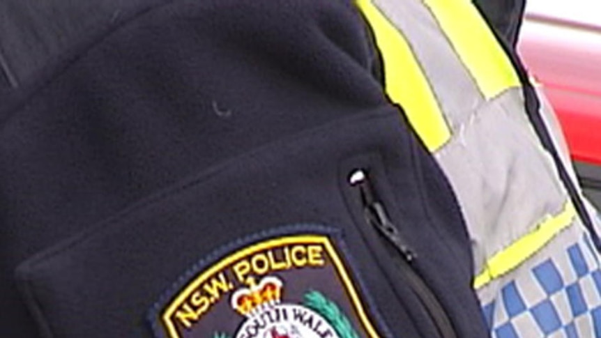 Close up of NSW Police crest on arm badge of police officer.