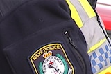 Close up of NSW Police crest on arm badge of police officer.