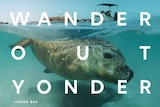 A seal in the ocean with the words 'Wander out Yonder' on the picture.