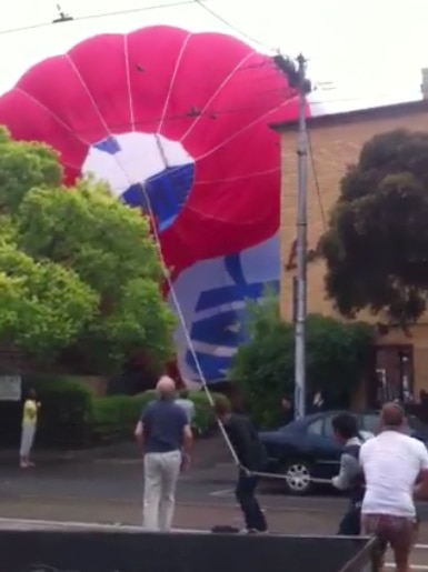 A hot air balloon lands in a car park on Carlisle Street in the Melbourne suburb of Balaclava.