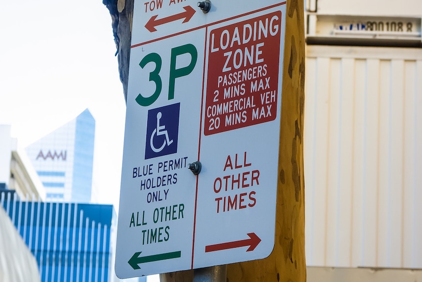 A road sign in Brisbane displaying loading zone, disability parking and clearway times.