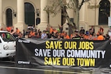 Protesters with a save our jobs, save our town banner at Trades Hall.