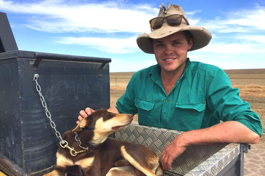 James Paterson petting cattle dog in ute tray.