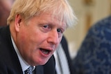 British Prime Minister Boris Johnson looks around with his mouth open during a Cabinet meeting.