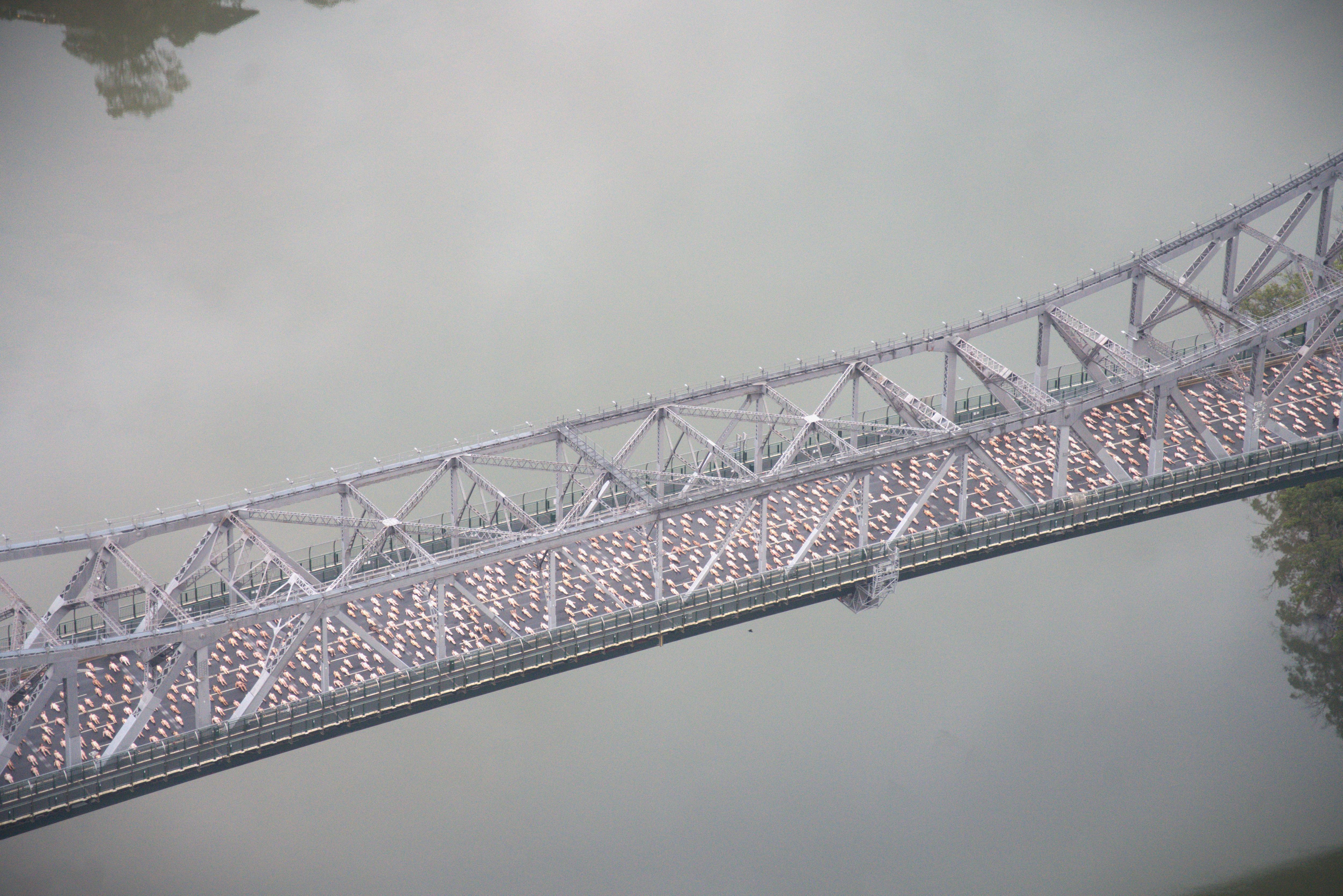 Thousands of naked people descend on Brisbane's Story Bridge to celebrate 30 years of Spencer