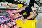 A man collects meat from a supermarket and puts it in a bucket