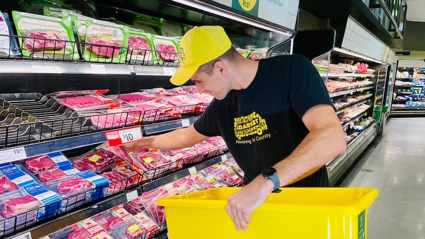 A man collects meat from a supermarket and puts it in a bucket