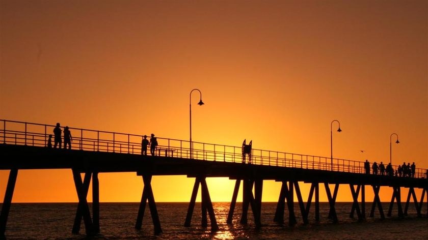 People stroll on Glenelg jetty in Adelaide at sunset on Christmas Day, 2007.