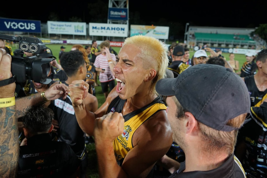 An AFL player celebrating in the NT