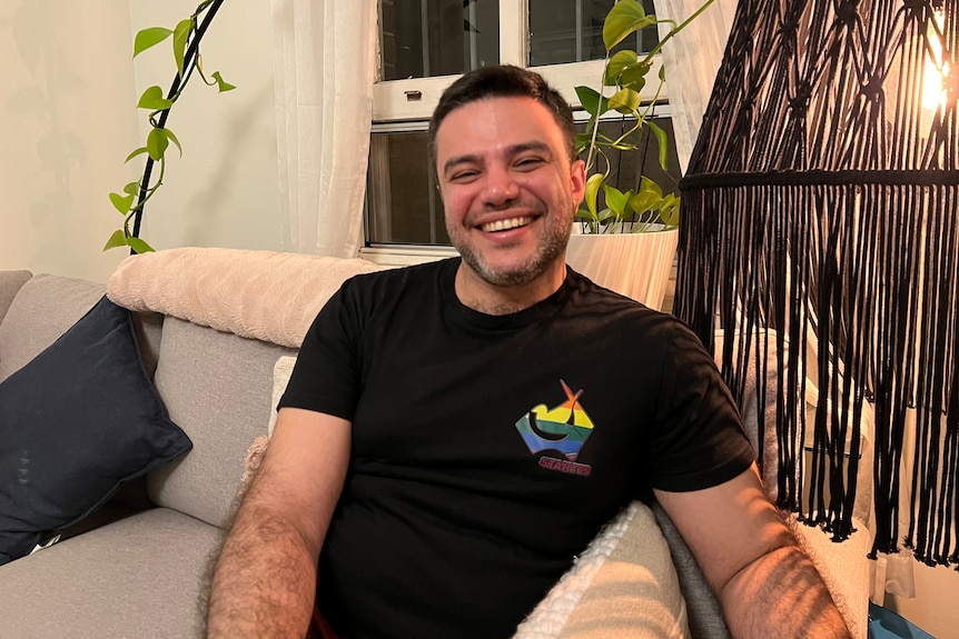 a man sitting on a lounge smiling