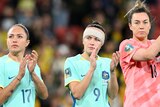 Matildas' Kyah Simon, Caitlin Foord and Mackenzie Arnold applaud the crowd after the FIFA Women's World Cup third-place play