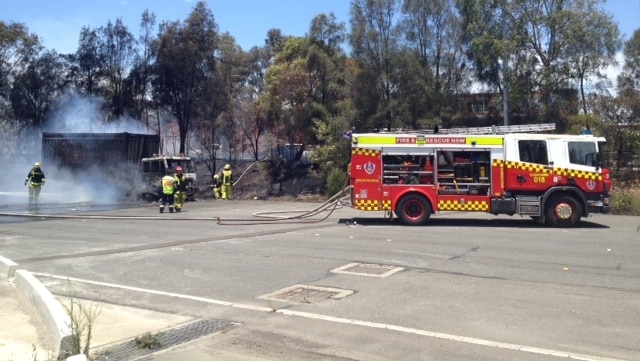 Fire fighters put out a truck fire