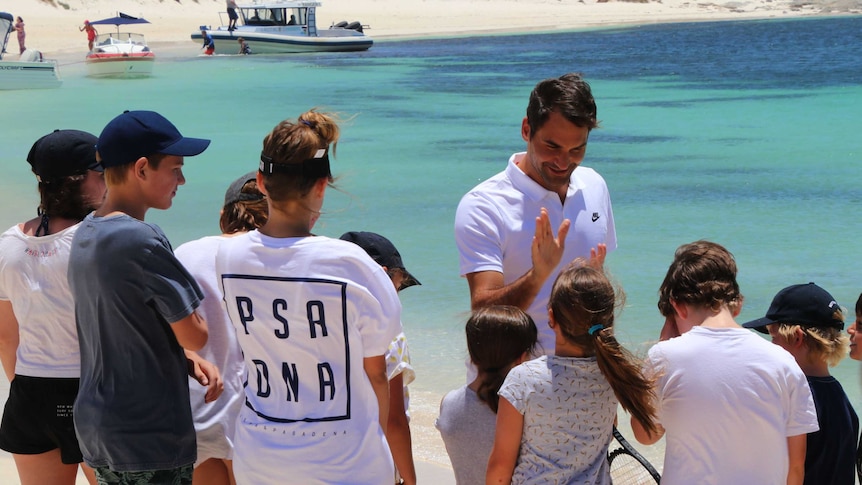 Tennis player Roger Federer talks to kids on the beach at Rottnest Island