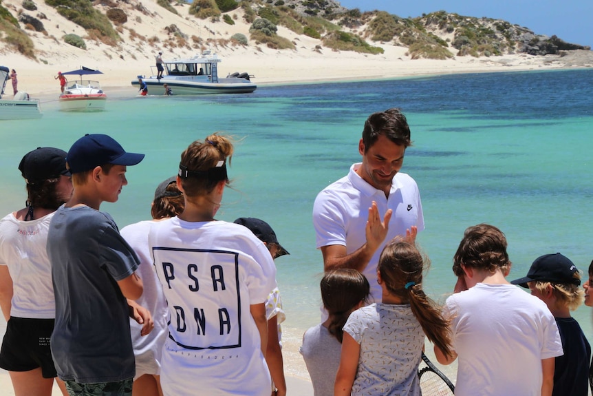 Tennis player Roger Federer talks to kids on the beach at Rottnest Island