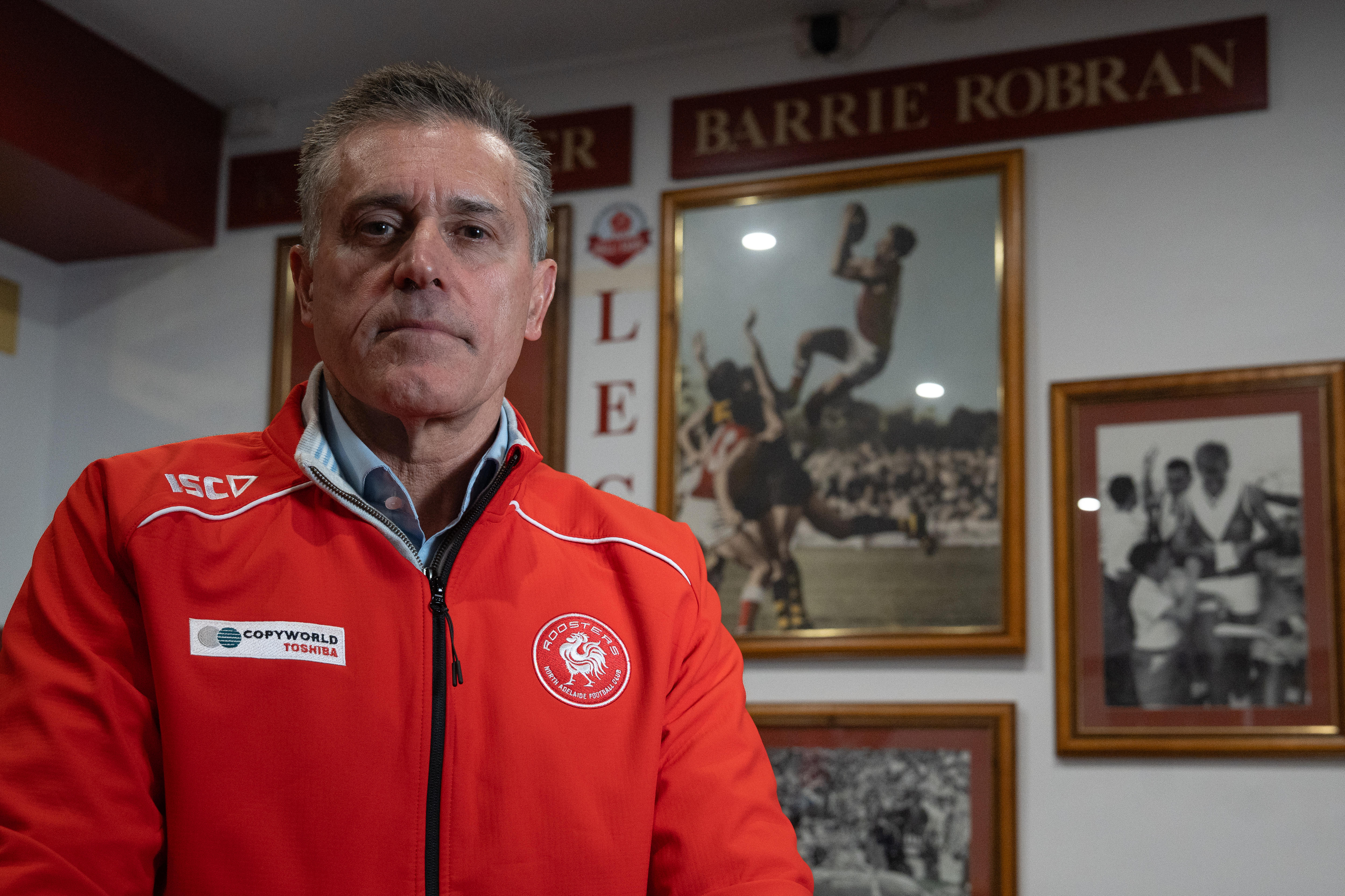 A man in a North Adelaide Football Club jacket.