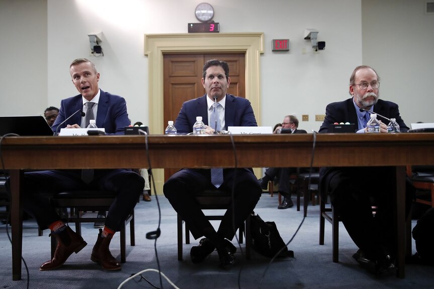 Troy Hunt sits alongside two other men in suits in US congress.