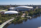 Adelaide Oval with the River Torrens and the pedestrian bridge with green signage on it
