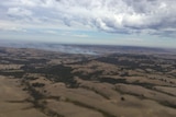 Smoke rises over the brown landscape of the area south of Adelaide.