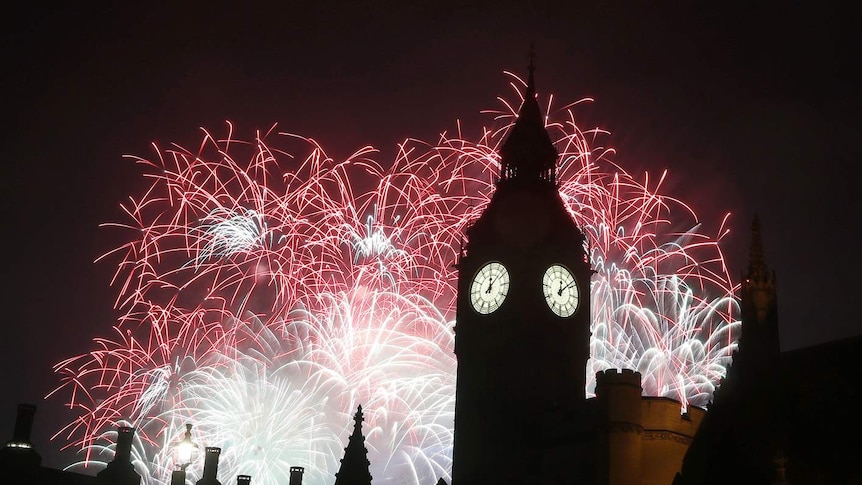 Pink and white fireworks explode behind London's Big Ben.