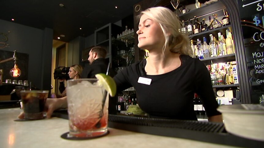 Woman serving drinks at a bar
