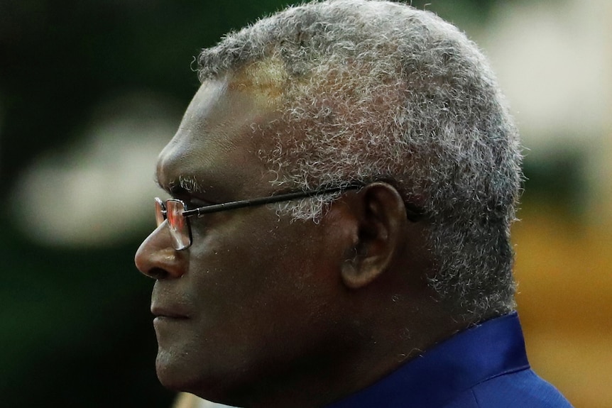 A side profile close up of MAnasseh Sogavare staring into the distance.  