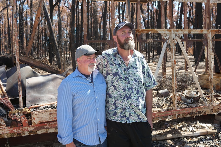 Craig Evans and Neil Trevaskis in front of their destroyed home.