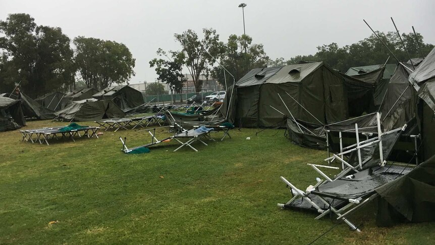 A tent city set up to house evacuees from Cyclone Trevor has been battered by torrential rain in Darwin.