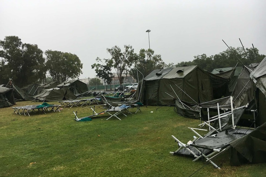 A tent city set up to house evacuees from Cyclone Trevor has been battered by torrential rain in Darwin.