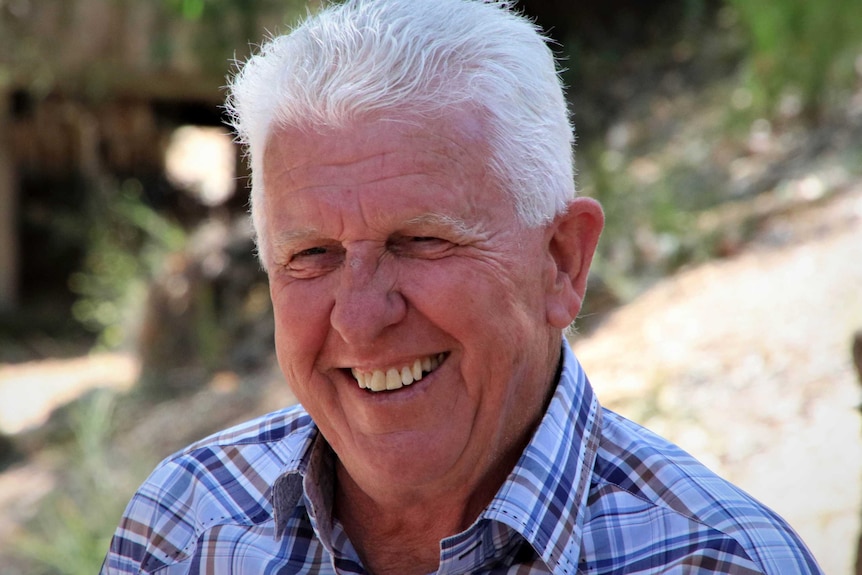 Geoff Baldwin smiles. He is outdoors, but the background is unclear.