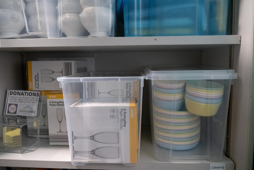 Plates and glasses in plastic tubs