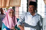 Malaysia's opposition leader Anwar Ibrahim and his wife Wan Azizah Wan Ismail during general elections in 2013