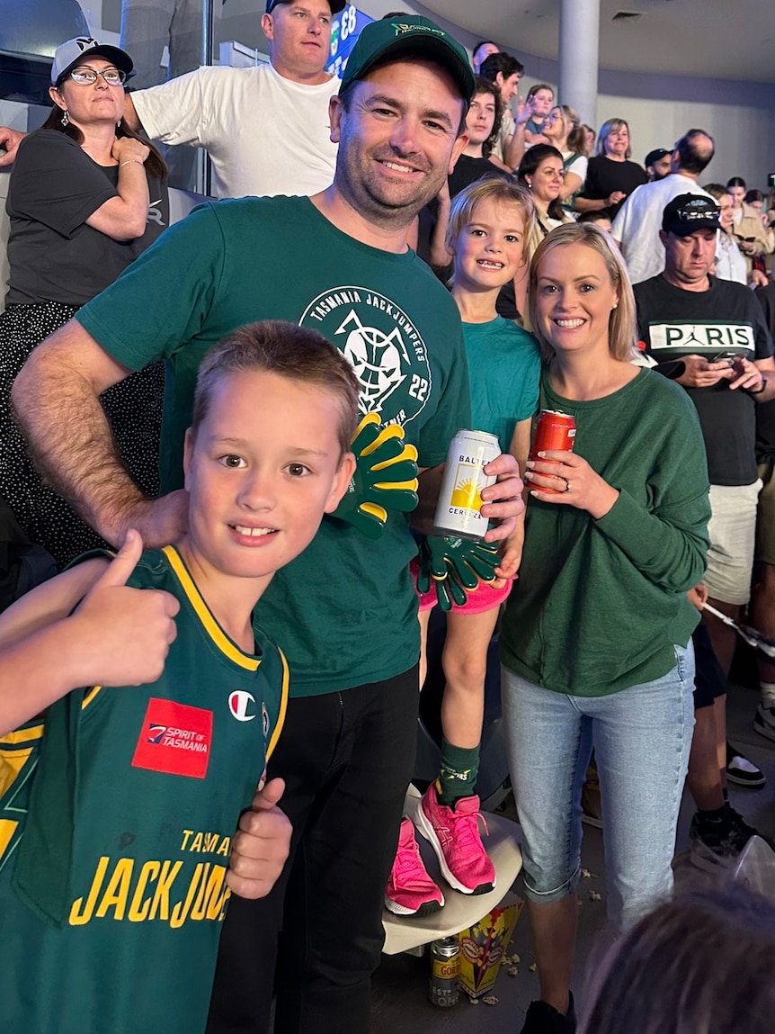 Dean Winter and family in a basketball stadium crowd.