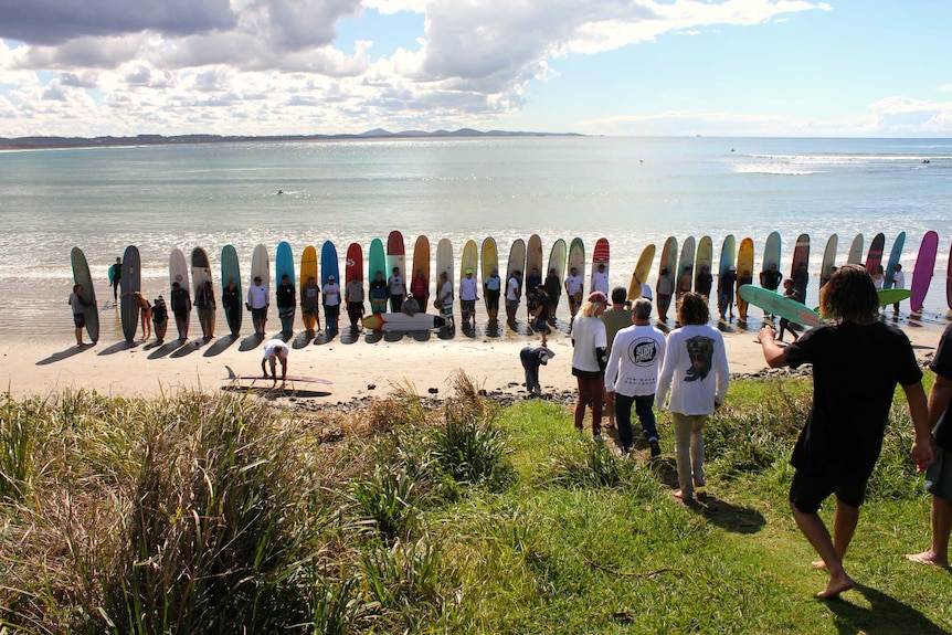 Surfers form a line at National Championships at Arrawarra Headland north of Coffs Harbour.