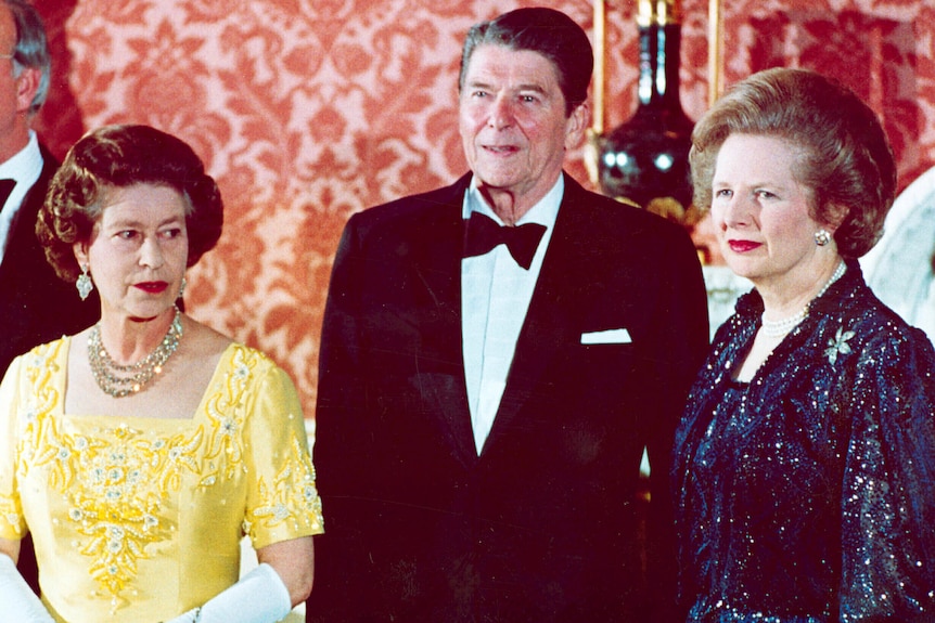 Queen Elizabeth glares at Margaret Thatcher as Ronald Reagan stands between them.