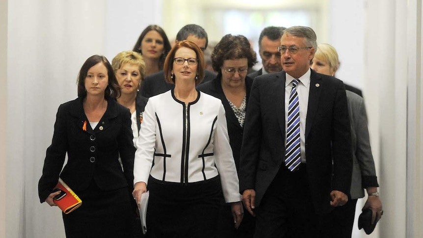 Prime Minister Julia Gillard, flanked by her supporters