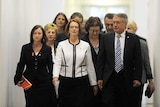 Prime Minister Julia Gillard, flanked by her supporters