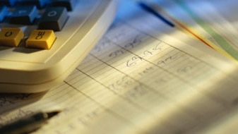 A calculator and pencil sit on top of a balance sheet (Thinkstock: Getty Images)