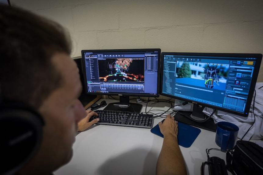 An inmate works on a computer, creating 3D animation.