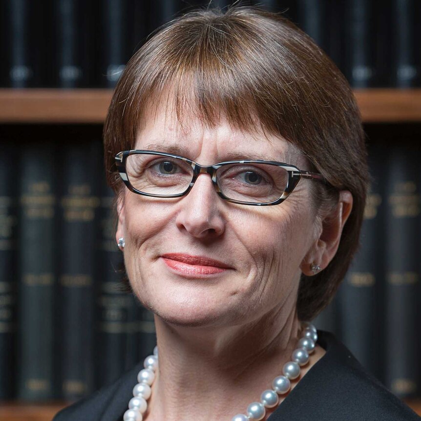 Official portrait of Justice Michelle Gordon in front of a bookcase.