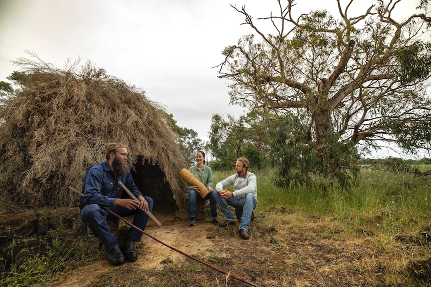 An indigenous guide demonstrates traditional practice with tourists at UNESCO World Heritage site Budj Bim.