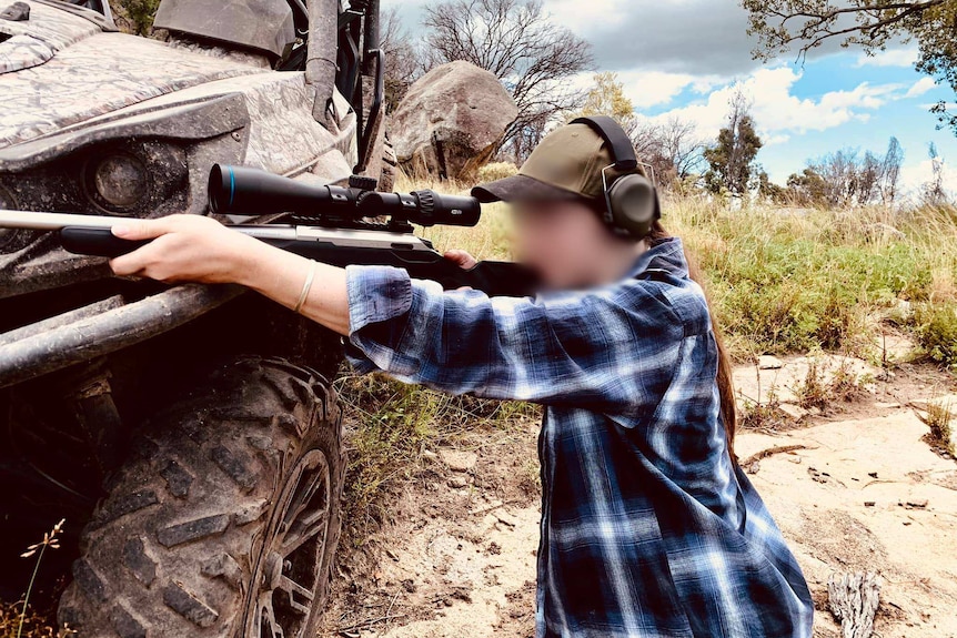 Teenager aiming a rifle