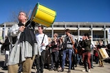 Gary France leads a protest rally against cuts to the ANU School of Music