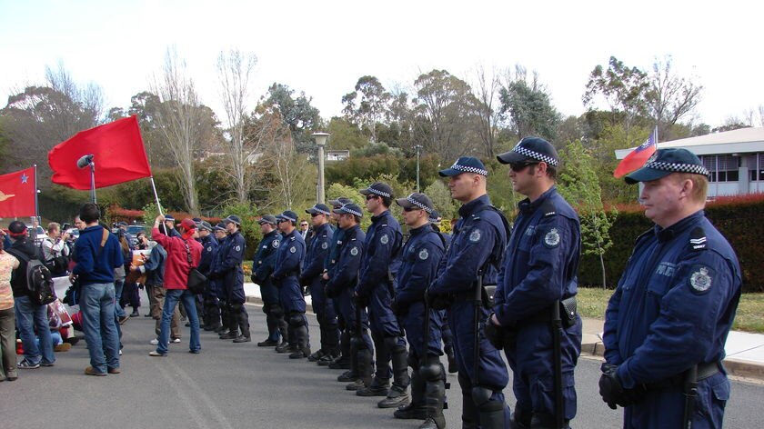 Police form a line to control protesters outside the Burmese Embassy.