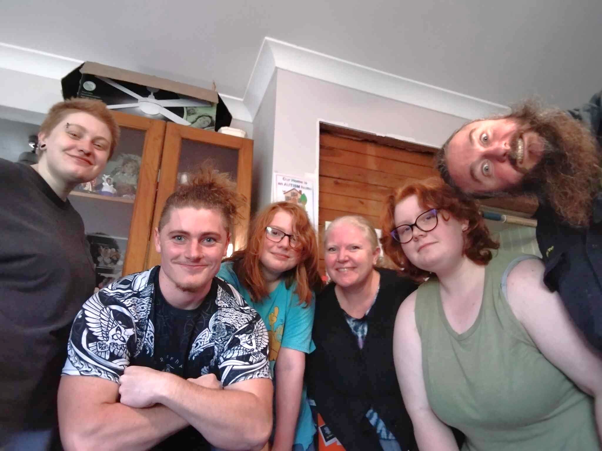 six people standing together and smiling.