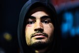 Rugby league player in a hoodie, arrives at a stadium