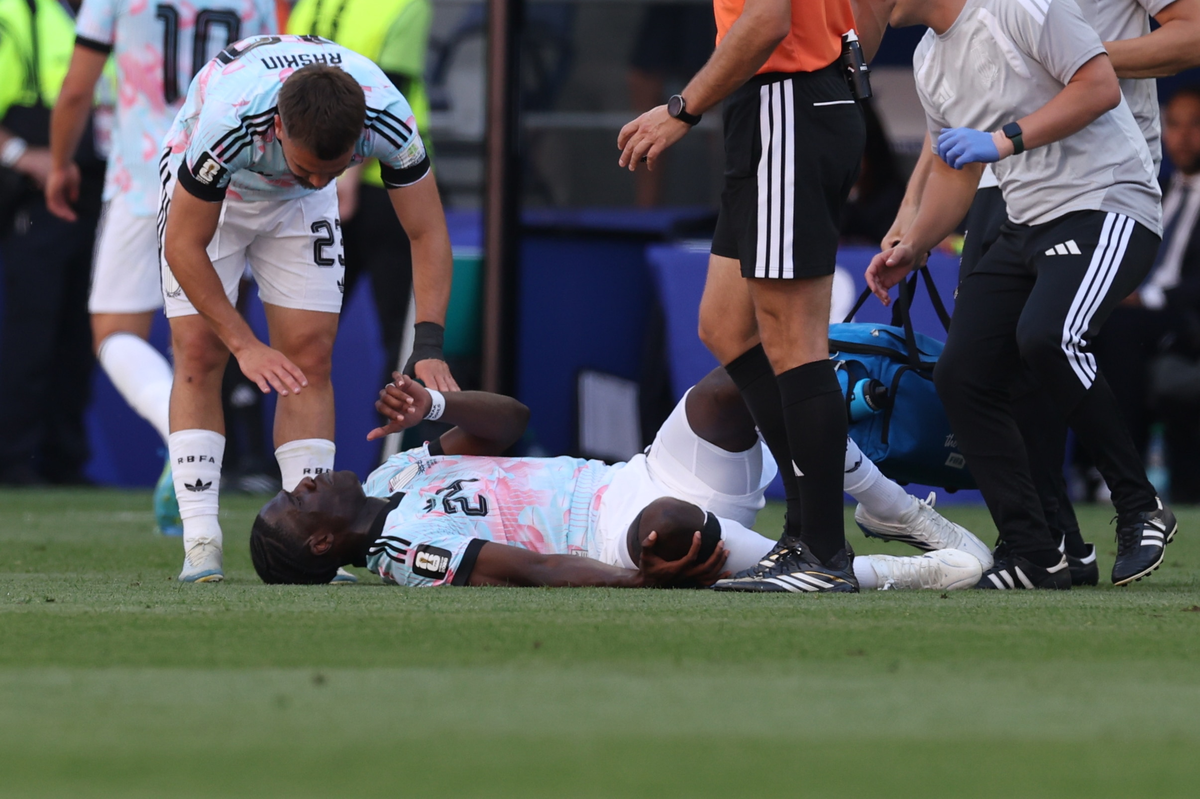 Amadou Onana is seen laying on the ground during a soccer match