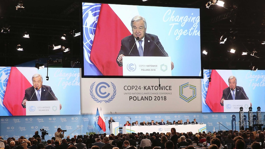 UN Secretary General Antonio Guterres appears on three screens when delivering a speech during the opening of COP24
