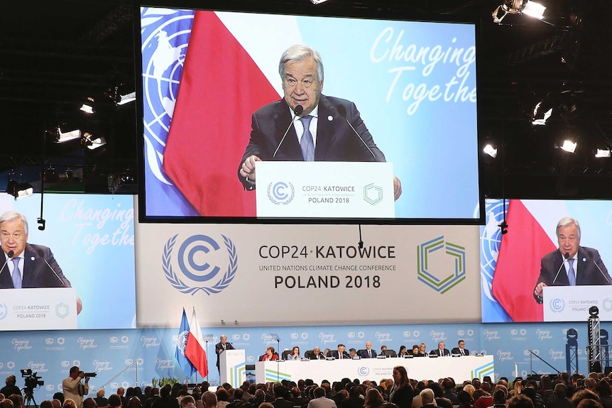 UN Secretary General Antonio Guterres appears on three screens when delivering a speech during the opening of COP24